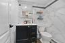 Bathroom featuring tile walls, baseboard heating, vanity, wood finished floors, and decorative backsplash