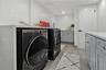 Washroom featuring cabinet space and washer and dryer