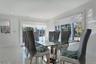 Dining area with ornamental molding and recessed lighting