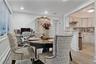Dining space featuring crown molding, baseboard heating, light wood-style flooring, and recessed lighting