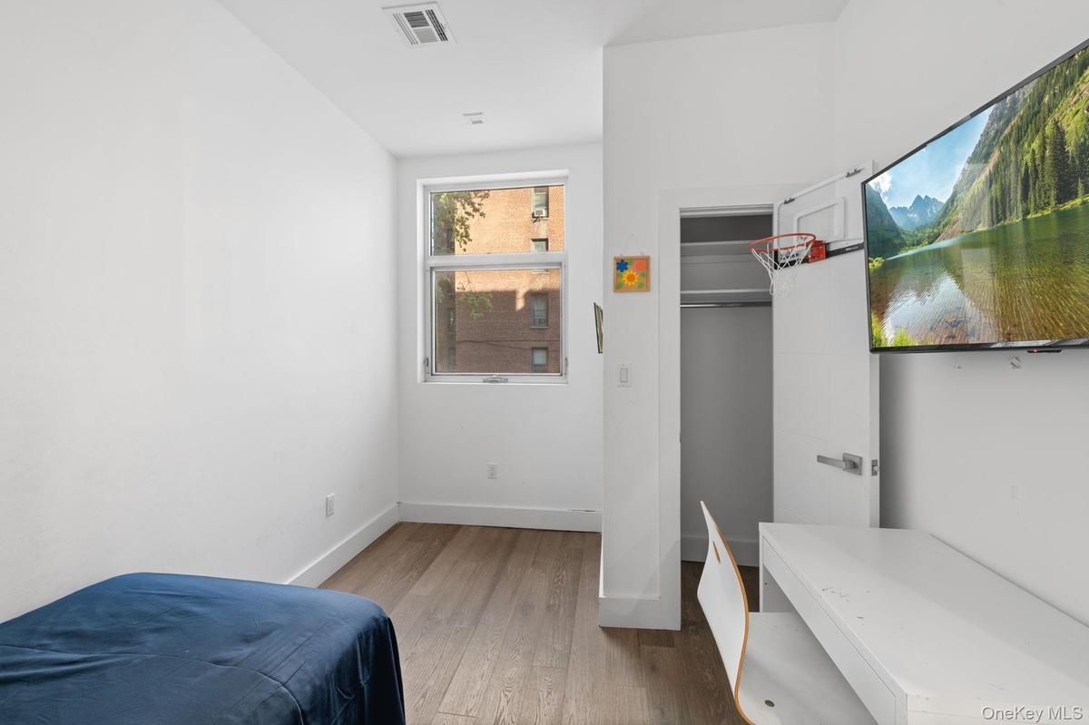 Bedroom featuring hardwood / wood-style floors and baseboards