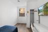 Bedroom featuring hardwood / wood-style floors and baseboards