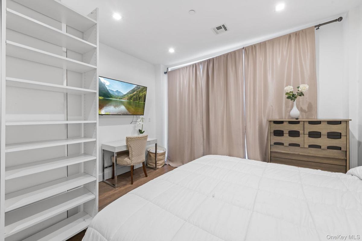 Bedroom featuring dark wood-style floors and recessed lighting