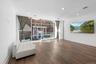 Unfurnished room with a wall of windows and dark wood finished floors