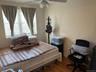 Bedroom with wood finished floors and ceiling fan