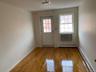 Entryway featuring a baseboard heating unit and wood finished floors