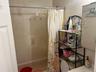 Full bathroom with shower / tub combo and vanity