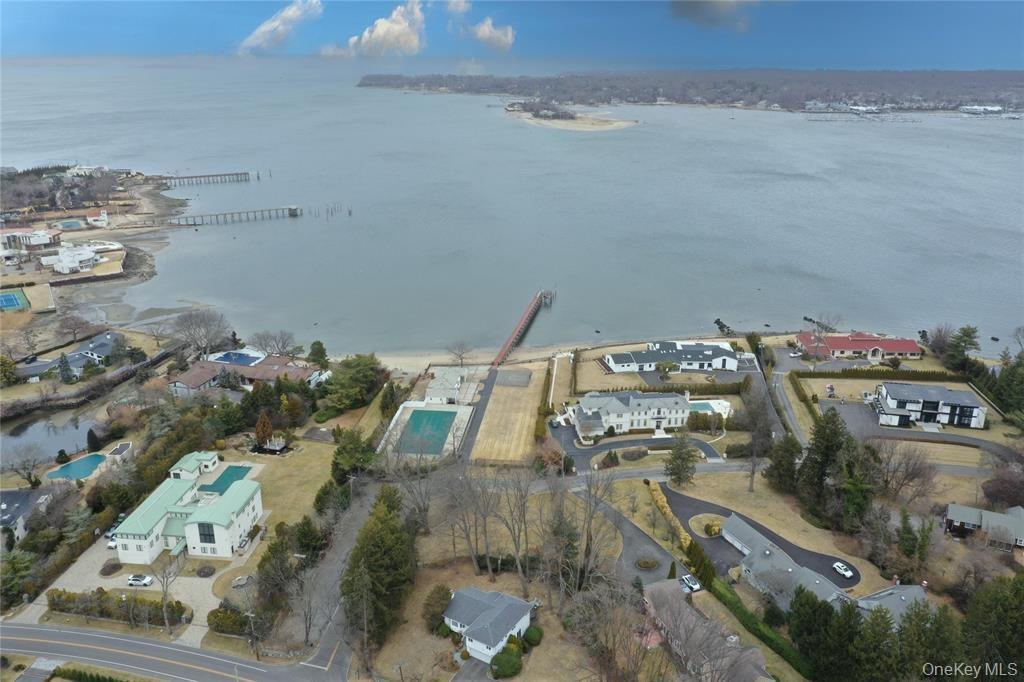 Aerial overview of property's location featuring nearby suburban area and a nearby body of water