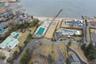 Aerial view of property and surrounding area with nearby suburban area and a large body of water