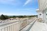 Balcony with a water view and a view of the beach