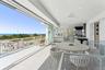 Wooden terrace featuring a ceiling fan, a water view, and outdoor dining area