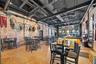 Dining room featuring brick wall and concrete floors