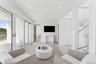 Living area featuring light wood-style floors, recessed lighting, and visible vents