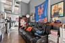 Living area featuring concrete floors and a high ceiling