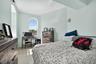 Bedroom featuring concrete floors and a desk