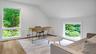 Office space with light hardwood / wood-style flooring and lofted ceiling