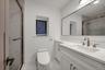 Full bathroom with a marble finish shower, vanity, and light marble finish floors