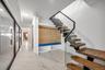 Mudroom featuring light marble finish floors and baseboards