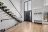 Foyer with stairs, a towering ceiling, and light wood-type flooring