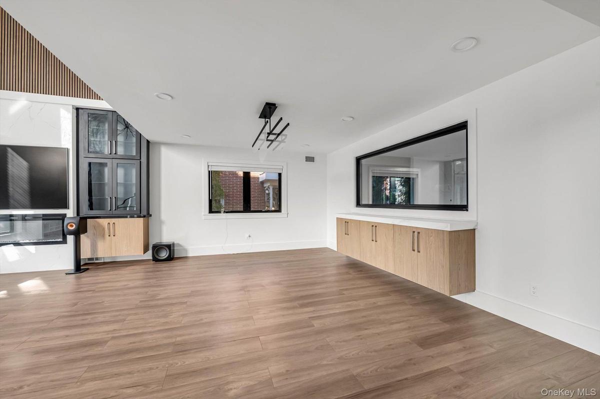 Unfurnished living room featuring light wood-type flooring and recessed lighting