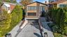 View of front of property with a garage and decorative driveway