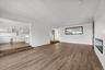 Unfurnished living room featuring recessed lighting and dark wood-style flooring