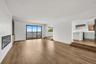 Unfurnished living room featuring recessed lighting and dark wood-type flooring