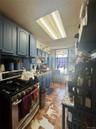 Kitchen featuring gas range, a drop ceiling, and light countertops