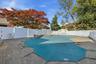 View of pool featuring a fenced backyard and a patio