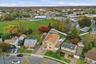 Aerial view of property's location with nearby suburban area