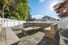Fenced backyard with an outdoor fire pit and a patio area