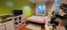 Bedroom with wood finished floors and baseboards