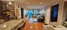 Corridor featuring crown molding, brick wall, light wood-style floors, a baseboard radiator, and recessed lighting