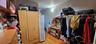 Walk in closet with light wood finished floors