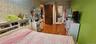 Bedroom with light wood-type flooring and wallpapered walls