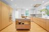 Kitchen with quartzite countertops and display island