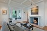 Wood burning fireplace with french limestone mantel bay window