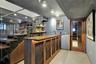 Custom walnut bar and display, walnut and steel staircase