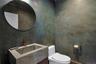 Powder room with custom sink and plaster walls