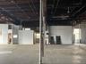 Misc room featuring a garage, water heater, and a towering ceiling