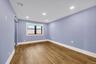 Spare room featuring a barn door, wood finished floors, and recessed lighting