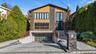 Modern home with decorative driveway, an attached garage, and stone siding
