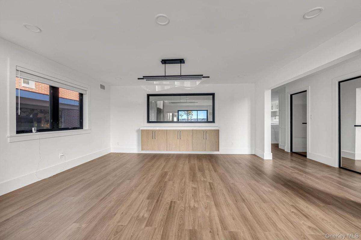 Unfurnished living room featuring light wood-type flooring and recessed lighting