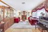 Living area with light wood-type flooring, a fireplace, and crown molding