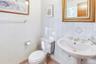 Half bathroom featuring toilet and baseboards