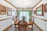 Dining area featuring plenty of natural light, crown molding, wallpapered walls, and a chandelier