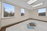 Empty room with baseboards and a paneled ceiling