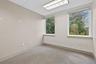 Empty room featuring a drop ceiling and carpet floors