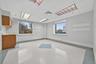 Spare room featuring a drop ceiling and light floors
