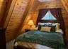 Bedroom with carpet floors and wooden walls